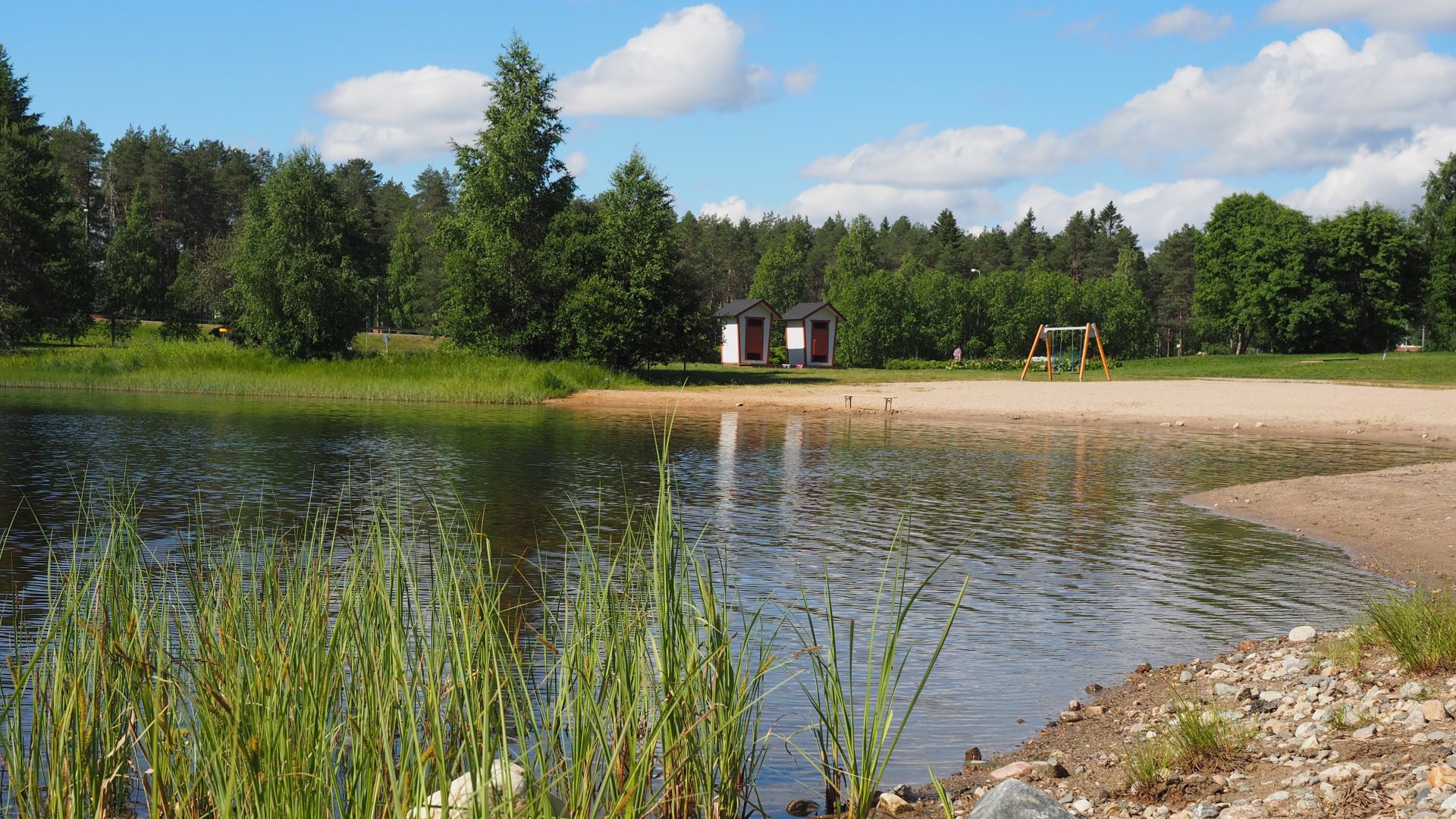 Kesäinen uimaranta, ihmisiä ei näy.